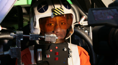 Benjamin übernahm dann von Erik Benjamin mit Helm und Kombi im Cockpit, teilweise durch den Zielcomputer verdeckt.